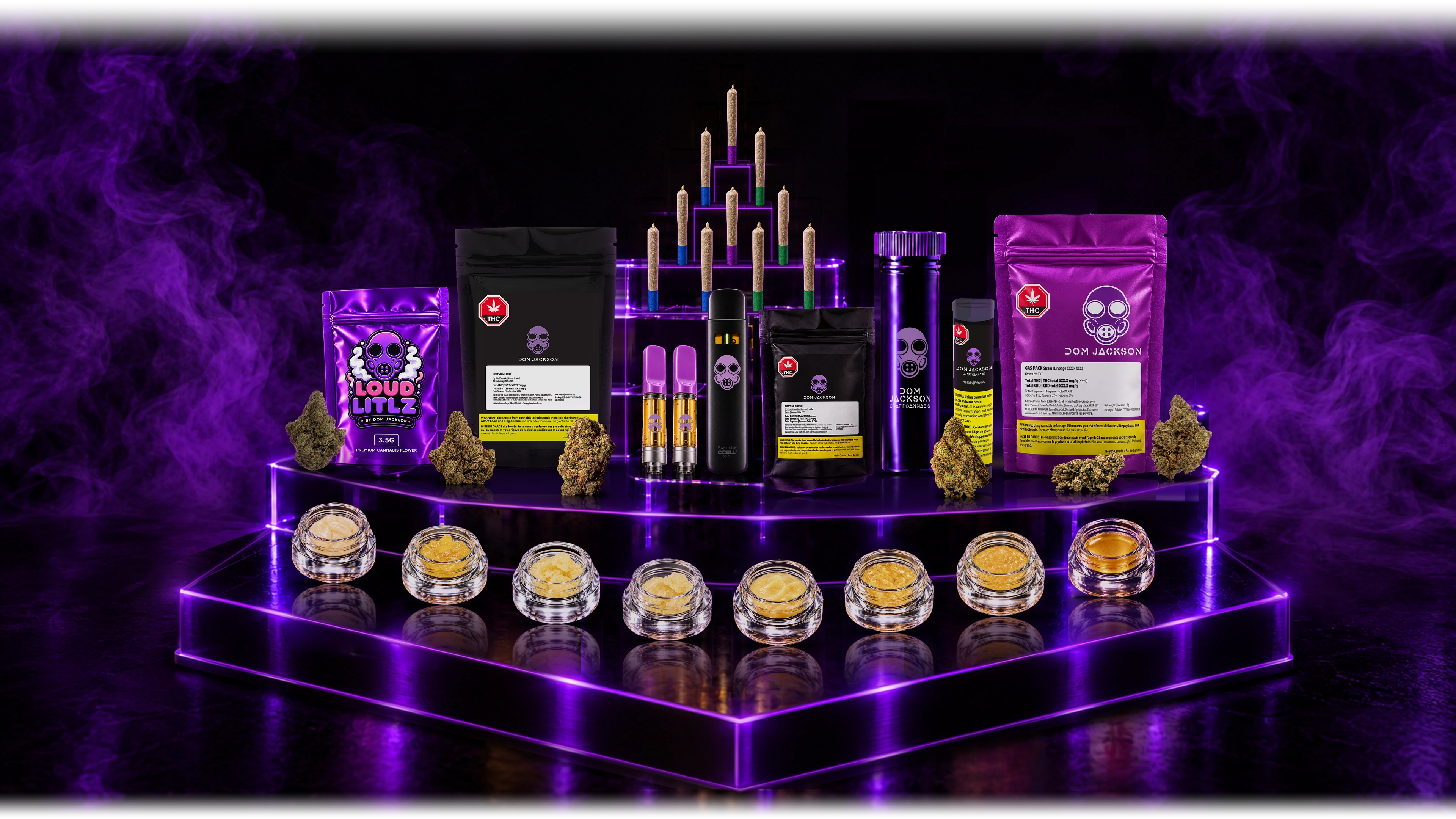Dom Jackson product family on a purple LED display, with eight concentrate jars arranged in a gentle curve, ten pre-rolls, 510 cartridges, a vape, flower packaging and nugs